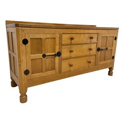 Mouseman - oak dresser, rectangular adzed top with raised back over three central drawers and two flanking cupboards, enclosed by panelled doors with wrought metal fixtures, the canted upright carved with mouse signature, on octagonal feet, by the workshop of Robert Thompson, Kilburn