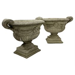 Pair of Classical design composite stone handled oval urn planter, decorated with linen swags and masks, gadroon moulded underbelly on acanthus leaf footed base on stepped square plinth