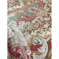 Large 19th century French Country House Aubusson carpet,  the central ivory and shell pink cartouche medallion containing rose bouquets, surrounded by scallop shells connected by pale teal rinceaux, fuschia scrolls interconnect within the field and rose garlands flank the medallion, the secondary field decorated with with ton-sur-ton burgundy club decoration, the corners and central edges decorated with shell cartouches with floral decoration with splayed acanthus leaves, extending round the guarded border are interlaced scrolling rinceaux patterns with repeating coral egg and dart motifs, circa 1850-1880
Provenance: property of a gentleman