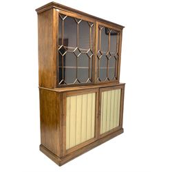 George III mahogany library bookcase on cupboard, the moulded cornice over two astragal glazed doors, each enclosing two adjustable shelves, two doors under with later glazed panels enclosing further adjustable shelves, raised on skirted base W159cm, H212cm, D56cm