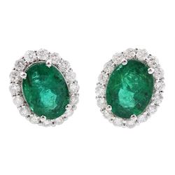 Pair of 18ct white gold oval emerald and round brilliant cut diamond cluster stud earrings, stamped, total emerald weight 2.85 carat, total diamond weight 0.78 carat , with World Gemological Institute Report