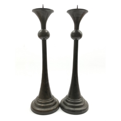  Pair of bronzed candlesticks, knopped stems on a tapered circular foot, H51cm  