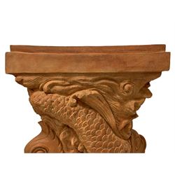 Regency design terracotta finish pedestal, modelled as two intertwined dolphins and decorated with shells, stepped rectangular top and plinth base