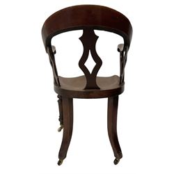 Victorian mahogany desk chair, bow-back over lozenge pierced splats and shaped saddle seat, raised on turned supports terminating to ceramic castors
