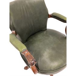 Late 19th century swivel desk chair, upholstered in green leather with scrolled arm rests 