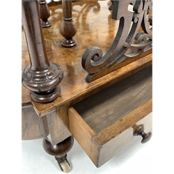 Victorian figured walnut Canterbury magazine rack, with two divisions raised on turned spindle gallery, pierce carved fretwork over one drawer with boxwood string inlay, raised on turned supports and brass and ceramic castors, W69cm