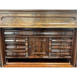 19th century Biedermeier figured mahogany secretaire cabinet, raised serpentine single drawer, frieze drawer over panelled fall front, the interior fitted with a combination of small drawers, cupboard and writing slide, three long drawers below, the uprights with carved scroll decoration 