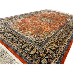 Fine Persian amber ground rug, the field with a central floral pole medallion surrounded by all-over scrolled foliate patterns and palmette motifs, the guarded indigo border with repeating interlocking foliage