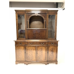 Reproduction mahogany breakfront illuminated cocktail display cabinet, with dentil cornice over glazed doors enclosing adjustable shelves, four drawers and four cupboards under, raised on bracket supports, W160cm, H194cm, D50cm