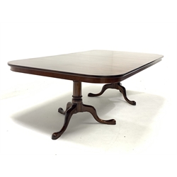 Late 20th century well figured mahogany twin pedestal dining table, the top raised on ring turned pedestals and triple splay supports, with one additional leaf - Manufactured in 1995 by Cumpers of Salisbury, 'Hand made furniture'  243cm x 130cm, H73cm (Extended)