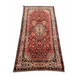 Persian Maleyer red ground carpet, lozenge medallion on a busy field enclosed by ivory border 320cm x 162cm