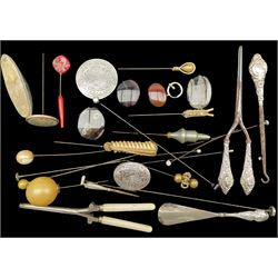 Collection of hat pins including one with the finial marked '9ct', silver handled curling tongs, shoe horn, glove button hook, small oval agate panel and other items