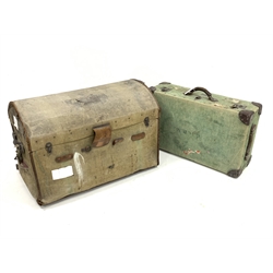 Early 20th century canvas covered dome top travelling trunk, with handle to each end and with old paper labels, interior baring label for 'D.H. Evans' department store, (W86cm) together with another canvas covered suitcase, (W77cm)