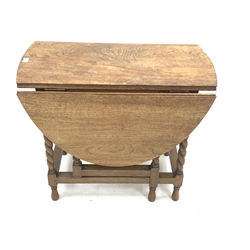 Early 20th century oak drop leaf table, oval top with moulded edge raised on spiral turned supports, with gateleg action, 