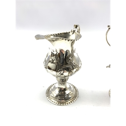 George III silver baluster cream jug embossed with trailing garlands on a pedestal foot London 1782 Maker Benjamin Mountigue and another of plain form with beaded edge London 1767, approx 6.7oz