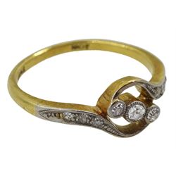 Early 20th century three stone diamond crossover ring, with diamond set shoulders, stamped 18ct, maker's marks W.G&S, probably William Griffiths & Sons