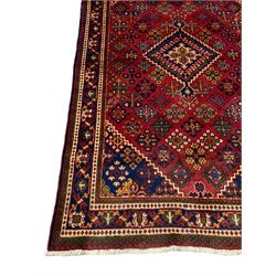 Persian Joshagan crimson round rug, the field decorated with a central lozenge and surrounded by diamonds containing various stylised plant or flower head motifs, the indigo border with trailing curling vines and palmettes