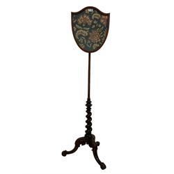 19th century mahogany pole screen, shield shaped needlework adjustable banner, spiral turned support above splayed cabriole feet with scroll carving