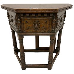 17th century design oak Credence side table, hinged top with rear gate-leg, canted front with strapwork decoration and central drawer, mounted by half turned mounts, on turned supports with rusticated lower halves united by moulded stretchers