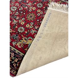 Persian ivory ground rug decorated with floral Boteh motifs (148cm x 130cm), Persian design red ground rug (162cm x 88cm), Turkish pale ground rug (144cm x 87cm)