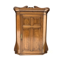 Georgian design oak wall hanging corner cupboard, raised back with incised scrolled detail over dentil cornice, four fielded panelled door enclosing two fixed shelves, W66cm