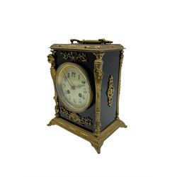 A French mantle clock c1900 in an ebonised case with brass mounts and carrying handle, enamel dial with Arabic numerals, minute markers and brass fleur di Lis hands, eight-day striking movement striking the hours on a bell. With an integral pendulum.



