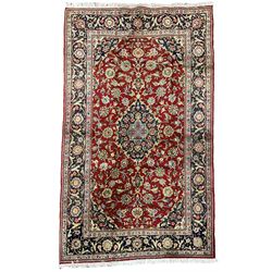 Persian Kashan red ground rug, the field decorated with interlacing foliate design, blue ground floral central medallion and spandrels, scrolling border decorated with stylised plant motifs