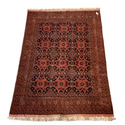 Tekke Turkoman rug of of geometric and stylised floral design, on a red field with multi-stripe border 