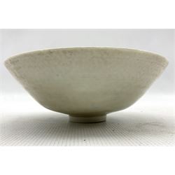 Chinese Ding ware style bowl with inner moulded decoration of figures on raised foot, D20cm