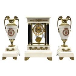 French - Late 19th century 8-day mantel clock in the Empire style, with matching white marble garniture de chiminea, two part dial with a narrow enamel chapter, roman numerals and an engine turned centre and ornate bezel to the edge, four reeded column supports, applied cast gilt metal swags on cast bracket feet, visible pendulum decorated with Greek mask surrounded by grapes and vine leaves, twin train rack striking movement, striking the hours and half hours on a suspended coiled gong, with a conforming pair of white marble urn garnitures with gilt metal handles on a stepped square base