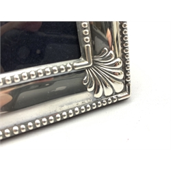 Silver table photograph frame with bead and shell border by Carr's of Sheffield, 2000 H22cm 