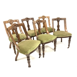 Set six Late Victorian oak dining chairs, lunette carved crest rail over upholstered seats, raised on turned front supports and castors
