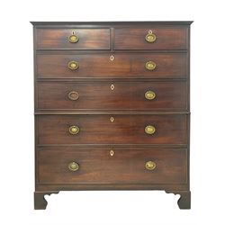 George III mahogany low chest-on-chest, fitted with two short over four long graduating drawers with cock-beaded facias and bone escutcheons, each with pressed brass handle plates and reeded ring handles, raised on shaped bracket feet