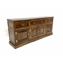 18th century style oak dresser, one long and two short drawers with pierced brass pull handles, over four panelled cupboards, raised on shaped plinth base, W197cm, H85cm, D44cm