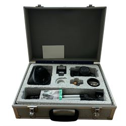 An Akita camera in fitted case with tripod and camera flash 