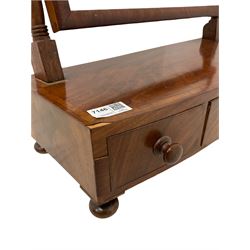 19th century mahogany swing toilet mirror, the adjustable mirror over one long and two short drawers, raised on bun feet 