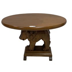 Mid-20th century carved teak and mahogany occasional table, oval top supported by carved lion figure