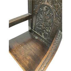 Pair of late 19th/ Early 20th century oak Wainscot chairs, the arched crest rail over floral and lunette carved panel back, out swept open arms, raised on turned front supports W68cm