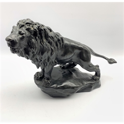 Early 20th century bronzed lion standing on rocky base after Gyorgy Vastagh, signed in the cast 44cm x 32cm