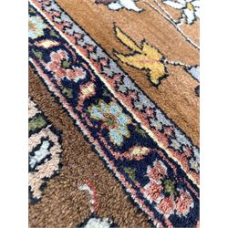 Persian design hand knotted ground rug, the brown and blue floral medallion on ivory field with brown spandrels, enclosed by double guarded border 280cm x 376cm
