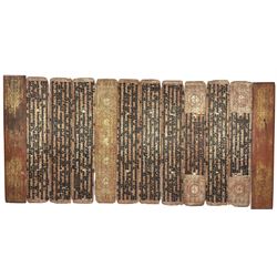 Burmese kammavaca manuscript, consisting of two lacquered wooden covers and ten double-sided folios with black, red and gold lacquer, L55cm x W10cm