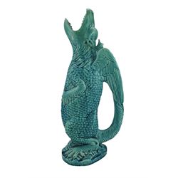 Burmantofts Faience turquoise-glaze Grotesque Dragon ewer, modelled as standing with a tilted head and gaping jaw, the wings forming the handle, impressed factory marks beneath, model no. 549, H39cm