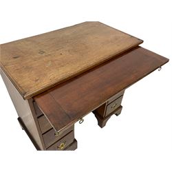 George II red walnut kneehole desk, moulded rectangular top over slide, fitted with one long drawer, six short drawers and central shallow drawer over cupboard, with shaped and pierced handles plates, on bracket feet