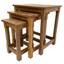 'Mouseman' oak nest of three tables, rectangular adzed tops on octagonal supports joined by pegged stretchers, each table carved with mouse signature, by Robert Thompson of Kilburn 