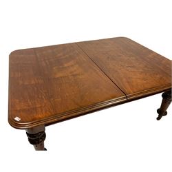 Early Victorian dining table, walnut rectangular moulded top with rounded corners, the base on turned supports carved with foliate and egg and dart decoration, brass and ceramic castors