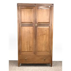 Early 20th century walnut double wardrobe, cornice with incised carved flutes and leaf roundels over two panelled doors enclosing interior fitted for hanging, one drawer under W108cm, H195cm, D50cm