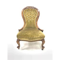 Victorian walnut nursing chair, spoon back with floral carved crest rail, upholstered in buttoned green crushed velvet, raised on scroll carved cabriole supports W59cm