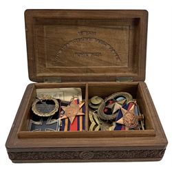 WWII Indian carved sandalwood box with presentation inscription and dated 1946, the cover with Royal Artillery crest and containing  Burma Star, German Iron Cross, 1939-1945 Star, various military badges etc