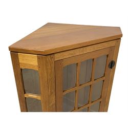 Knightman - oak panelled corner cabinet, single astragal glazed door with chamfered glazing bars, with wrought iron fittings and handle, carved with knight signature, by Horace Knight of Balk, Thirsk