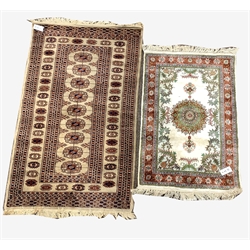 Afghan Bokhara style beige ground rug, with gul motif enclosed by triple guarded border, (141cm x 80cm) and a silk on cotton cream ground rug, (104cm x 63cm)